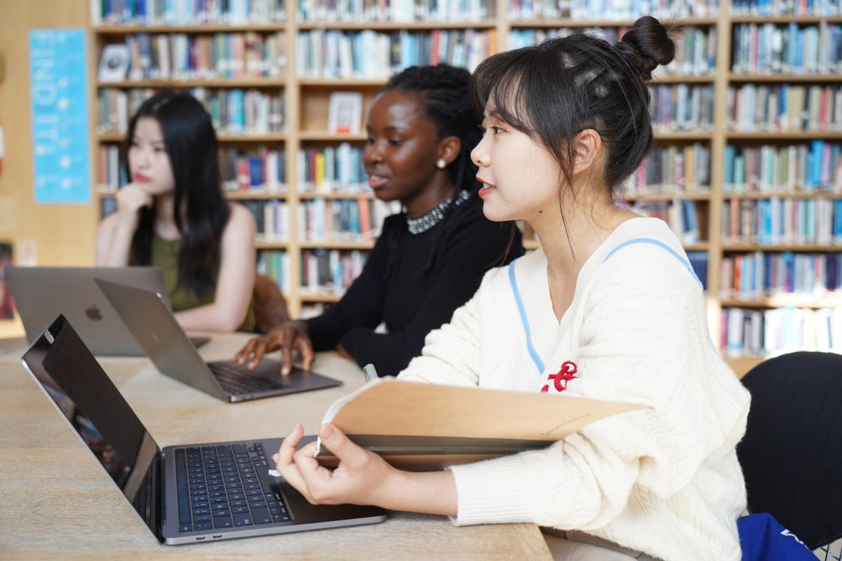 Postgraduate students with laptops in Darwin College